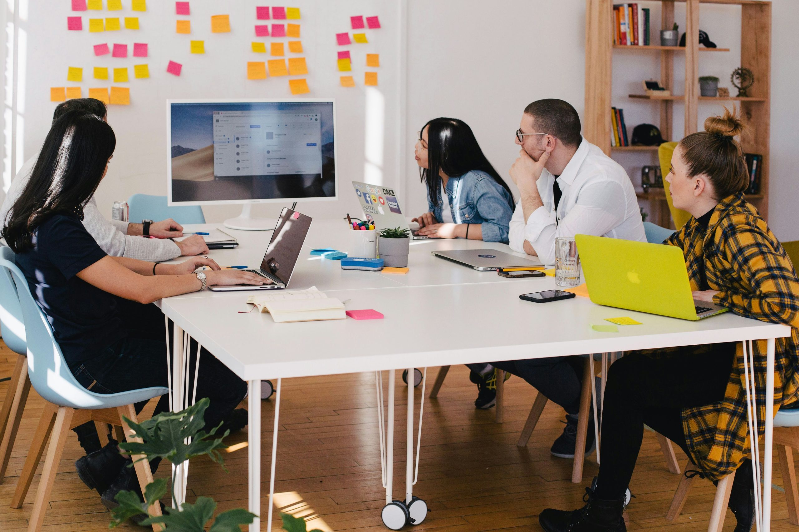 Illustrative photograph of colleagues collaborating around a table in an office